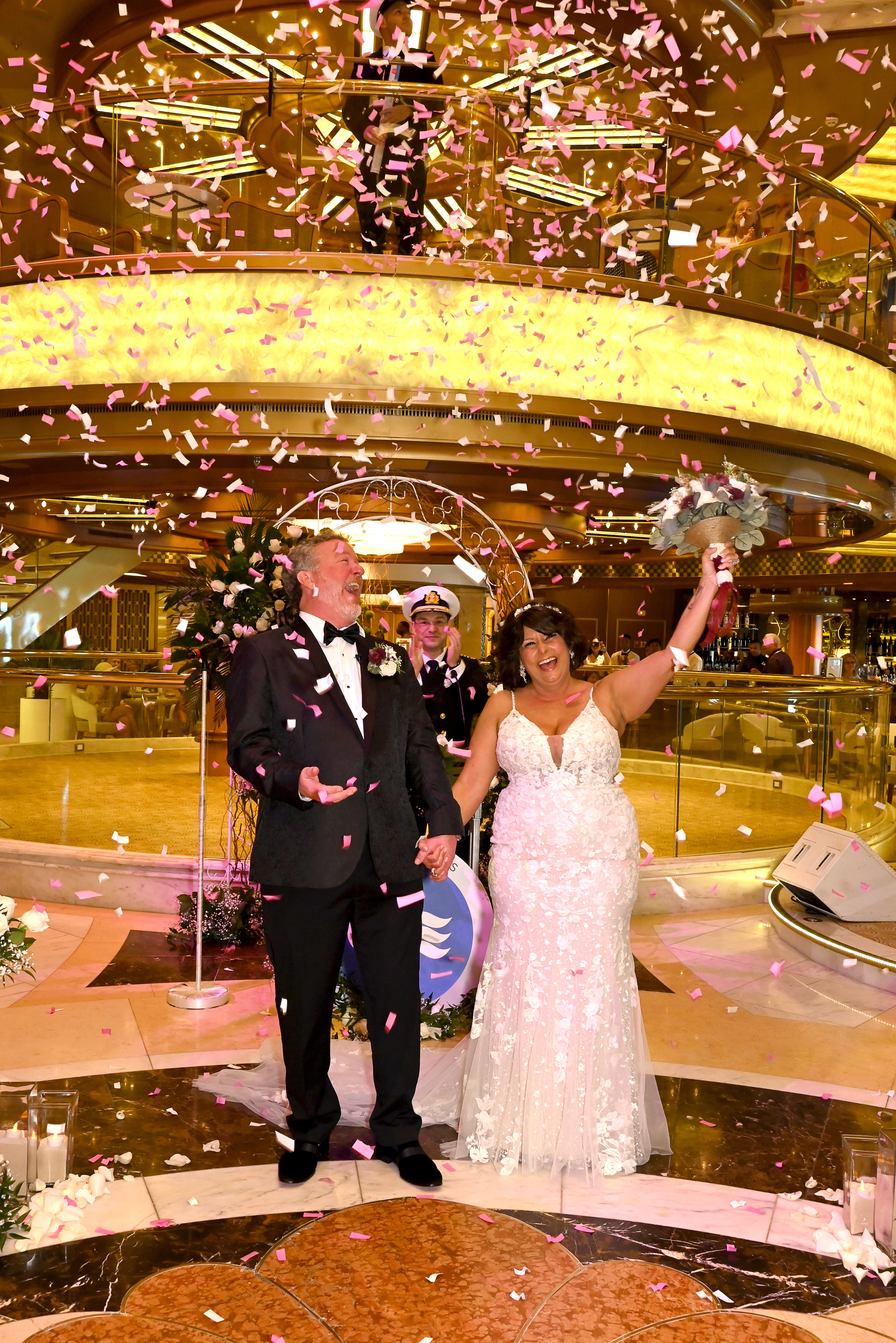 Couple celebrating with confetti aboard ship